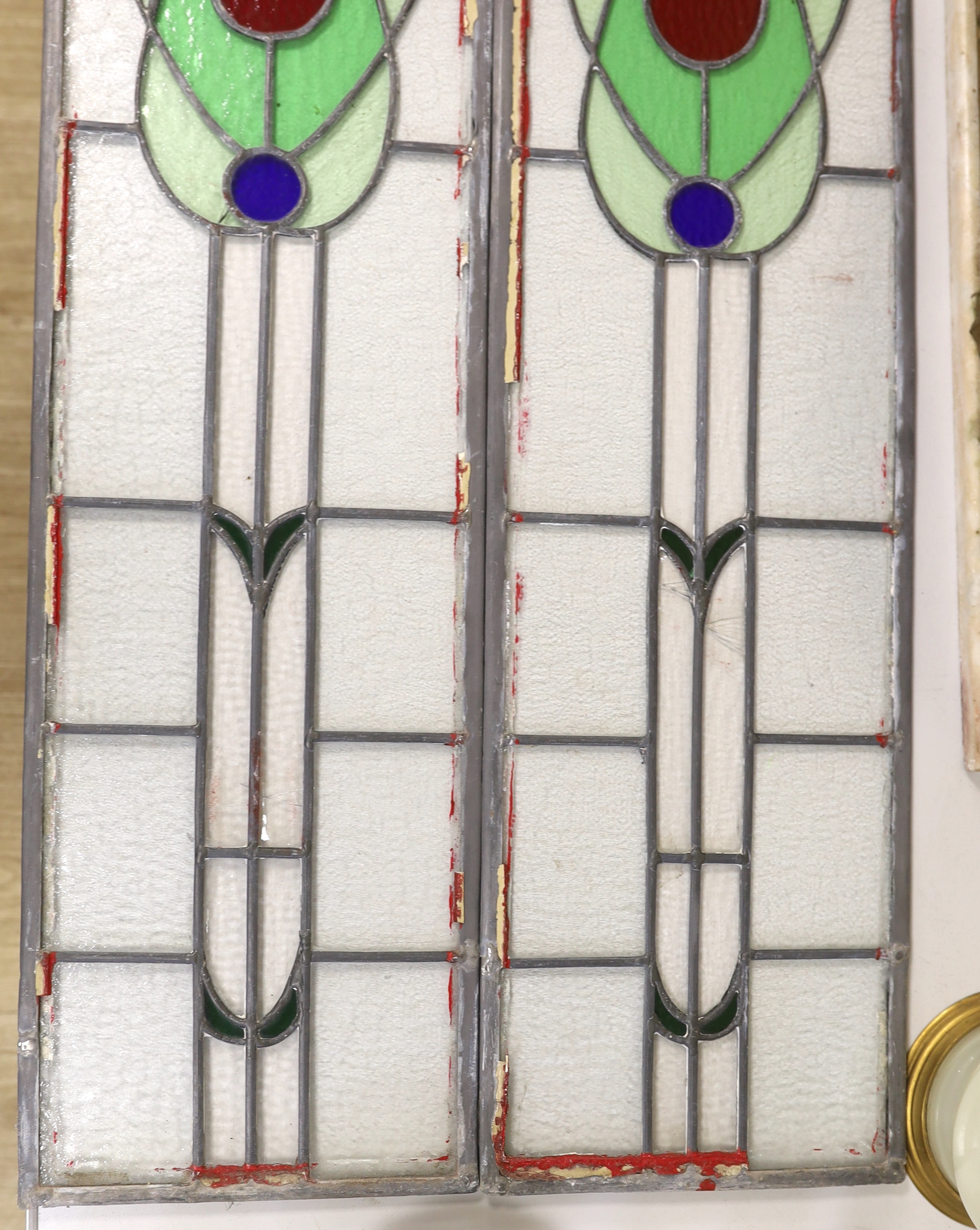 A pair of stained glass leaded panels, 98cm high x 25.5cm wide